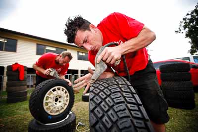 1-August-2010;APRC;Asia-Pacific-Rally-Championship;Australia;Imbil;QLD;Queensland;Sunshine-Coast;Team-MRF;Wayne-Moore;auto;mechanic;motorsport;portrait;racing;service-centre;service-park;tyres;wide-angle