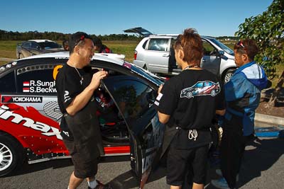 6;13-May-2011;6;APRC;Asia-Pacific-Rally-Championship;Australia;Caloundra;IROQ;International-Rally-Of-Queensland;Mitsubishi-Lancer-Evolution-IX;Pertamina-Cusco-Racing;QLD;Queensland;Rifat-Sungkar;Scott-Beckwith;Sunshine-Coast;auto;crew;mechanics;motorsport;portrait;racing;shakedown;team;wide-angle