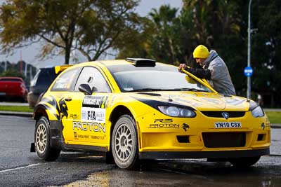 2;15-July-2011;2;APRC;Asia-Pacific-Rally-Championship;Chris-Atkinson;International-Rally-Of-Whangarei;NZ;New-Zealand;Northland;Proton-Motorsports;Proton-Satria-Neo-S2000;Rally;Stephane-Prevot;Whangarei;auto;garage;motorsport;pre‒event;racing;service-park;telephoto