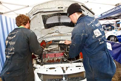 8;15-July-2011;8;APRC;Asia-Pacific-Rally-Championship;International-Rally-Of-Whangarei;Mitsubishi-Lancer-Evolution-IX;NZ;New-Zealand;Northland;Rally;Whangarei;auto;engine-bay;garage;mechanics;motorsport;portrait;pre‒event;racing;service-park;wide-angle