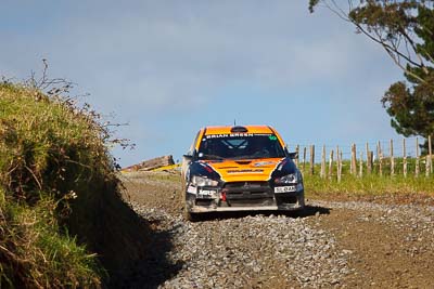 10;10;16-July-2011;APRC;Asia-Pacific-Rally-Championship;International-Rally-Of-Whangarei;Mitsubishi-Lancer-Evolution-X;NZ;New-Zealand;Northland;Rally;Sloan-Cox;Tarryn-Cox;Whangarei;auto;garage;motorsport;racing;special-stage;telephoto