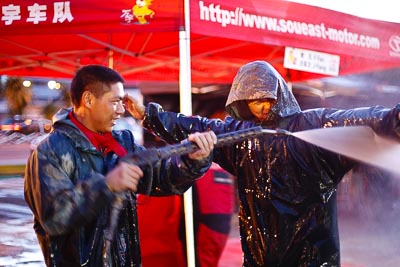 16-July-2011;50mm;APRC;Asia-Pacific-Rally-Championship;International-Rally-Of-Whangarei;NZ;New-Zealand;Northland;Rally;Soueast-Motor-Kumho-Team;Topshot;Whangarei;auto;garage;mechanic;motorsport;portrait;racing;service-park;water-spray