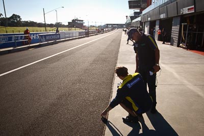 24-February-2012;Australia;Bathurst;Bathurst-12-Hour;Michelin;Mt-Panorama;NSW;New-South-Wales;atmosphere;auto;endurance;motorsport;paddock;pitlane;portrait;racing;technician;wide-angle