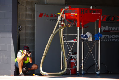 8-February-2013;Australia;Bathurst;Bathurst-12-Hour;Grand-Tourer;Mark-Walker;Mt-Panorama;NSW;New-South-Wales;atmosphere;auto;endurance;fuel-station;hose;motorsport;paddock;photographer;pitlane;portrait;racing;telephoto